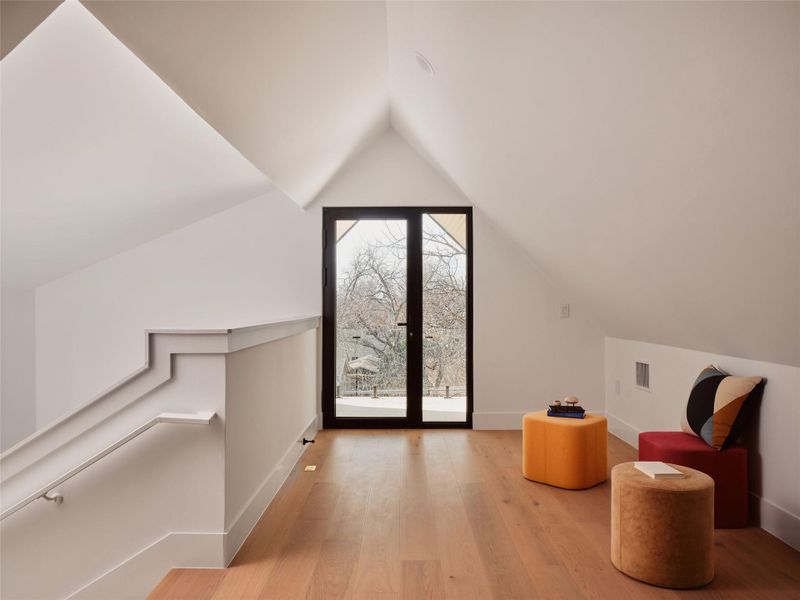 Bonus room with light wood finished floors and baseboards