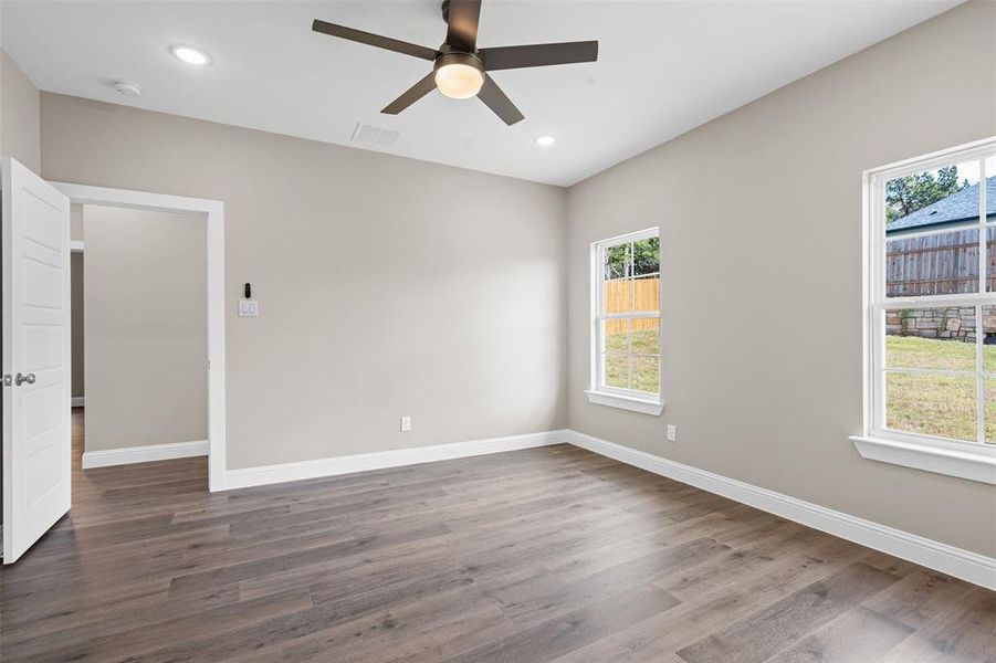 Unfurnished room featuring dark wood-type flooring, recessed lighting, and ceiling fan Unfurnished room featuring dark wood-type flooring, recessed lighting, and ceiling fan