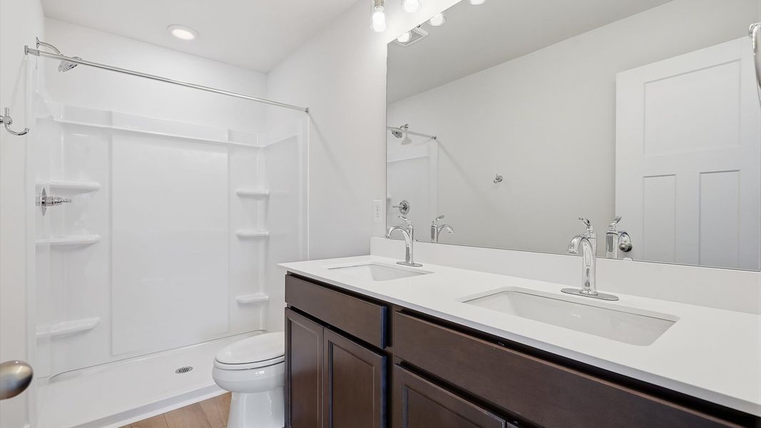 Notable primary suite with dual vanities and walk-in shower in this prime Anderson villa
