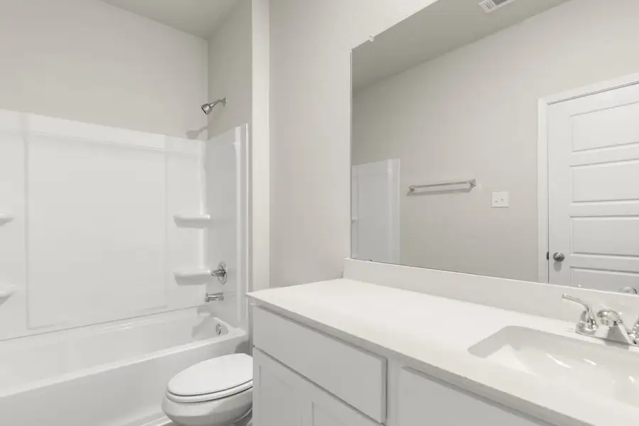 Image of a bedroom with a white double vanity, a large mirror, a white shower with a tub Image of a bedroom with a white double vanity, a large mirror, a white shower with a tub