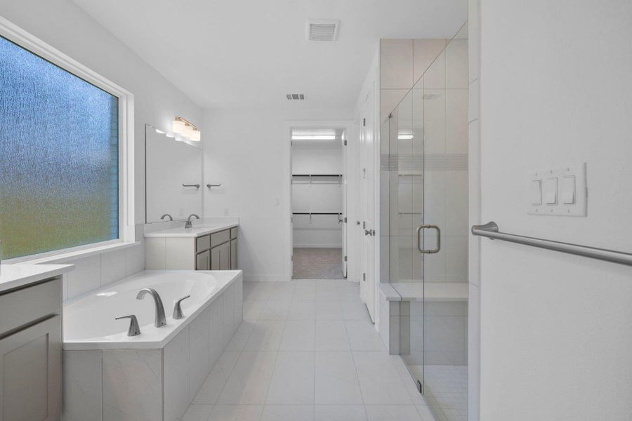 Primary Bath retreat with dual vanities, garden tub & walk-in shower Primary Bath retreat with dual vanities, garden tub & walk-in shower
