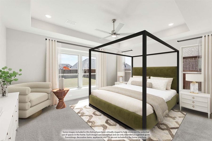Master bedroom with four-poster bed, tray ceiling, ceiling fan, and large windows with backyard view Master bedroom with four-poster bed, tray ceiling, ceiling fan, and large windows with backyard view