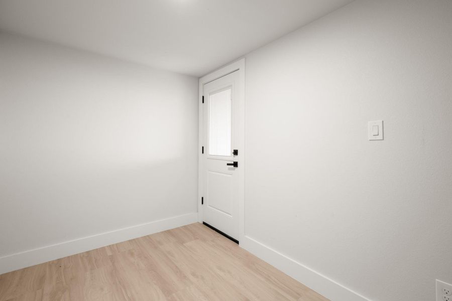 Unfurnished room featuring baseboards and light wood-type flooring