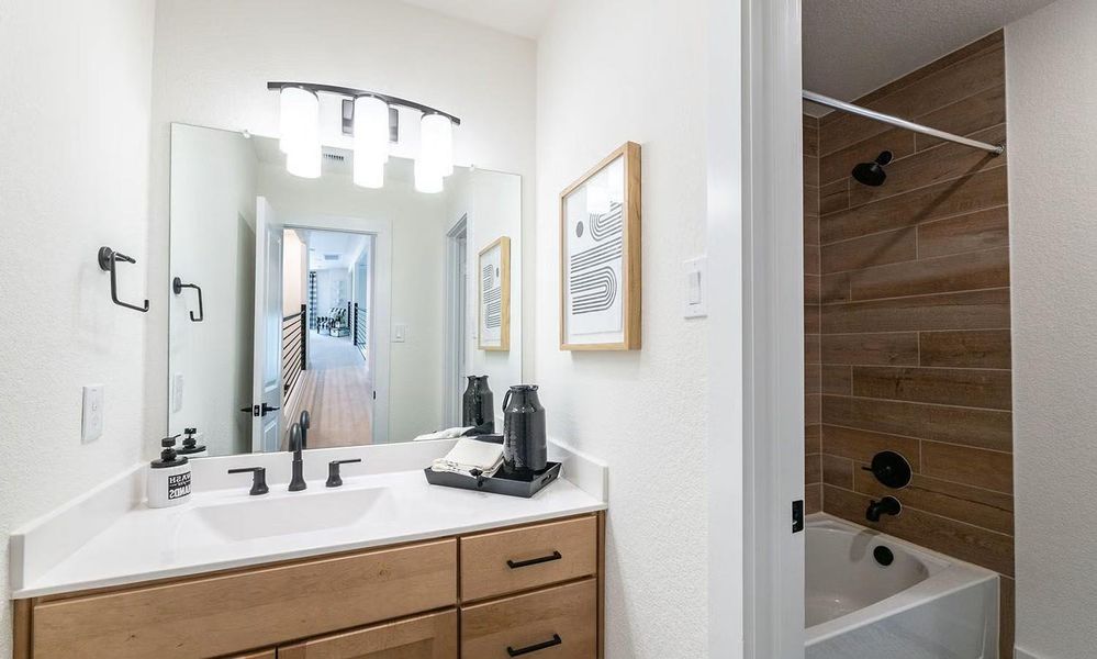 Additional bathroom view featuring a tub and shower combination with a clean vanity design, providing convenience for upstairs bedrooms. **Photos are representative only and may vary as built.**