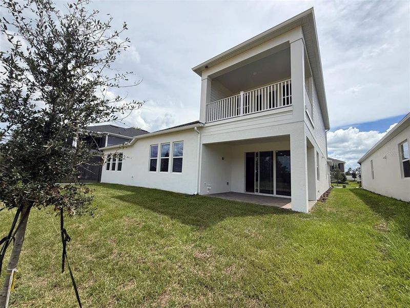 Front exterior of a new home in Emerson Pointe, Apopka, FL, highlighting curb appeal (Image 1).