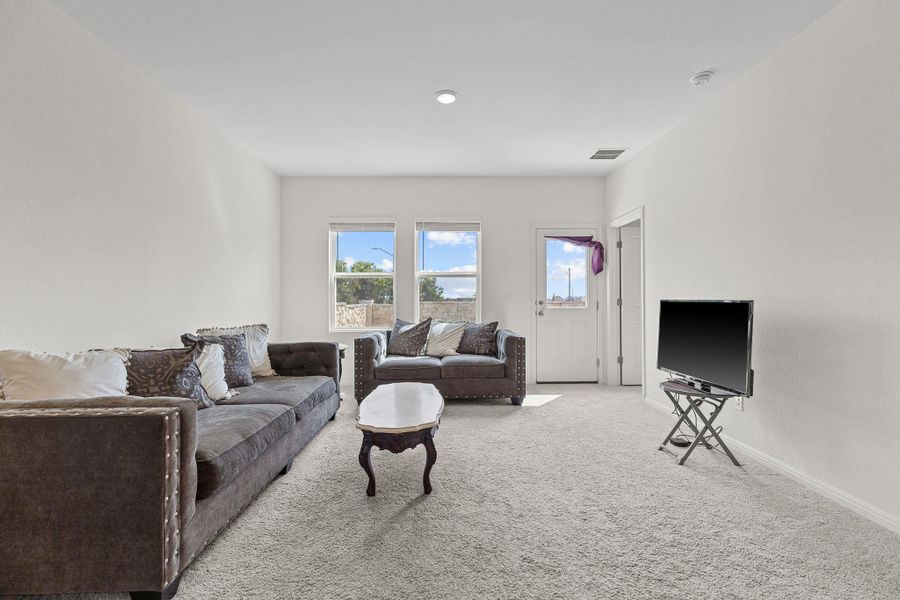 Living area with carpet flooring and baseboards Living area with carpet flooring and baseboards