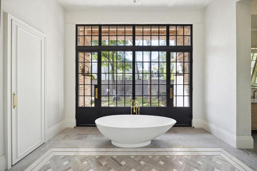 View of the bathtub and iron doors.