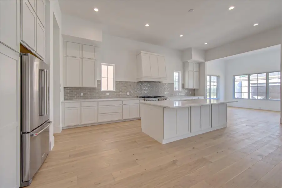 Virtual rendering of the completed designer kitchen showcasing modern cabinetry, sleek countertops, premium appliances, expansive island seating, and an open-concept layout ideal for entertaining and everyday living.