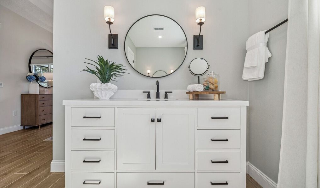 Primary bath features dual freestanding vanities