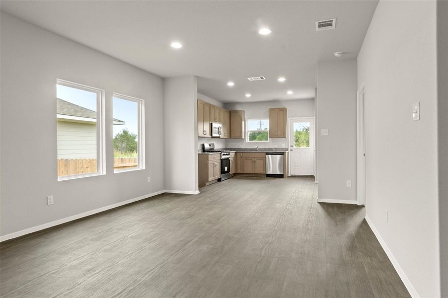 Unfurnished living room with recessed lighting and wood finished floors