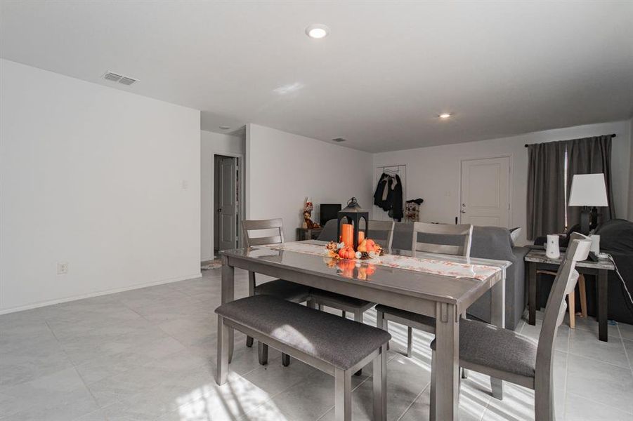 Dining room featuring recessed lighting and light tile patterned floors