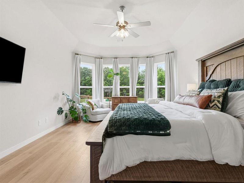 Private primary suite with spacious layout and peaceful views of the surrounding property.