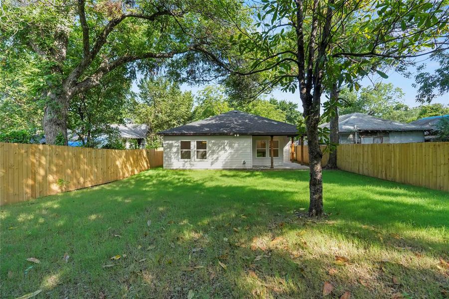 Rear view of house featuring a fenced backyard