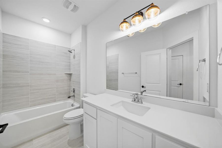 Full bathroom featuring shower / washtub combination, vanity, and recessed lighting