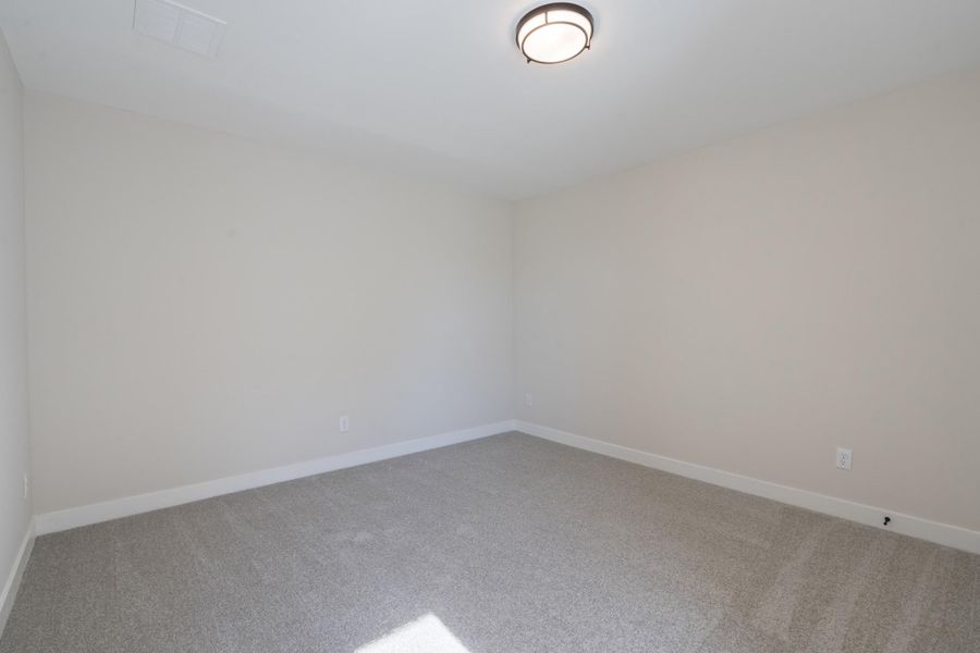 Empty room featuring light carpet and baseboards Empty room featuring light carpet and baseboards
