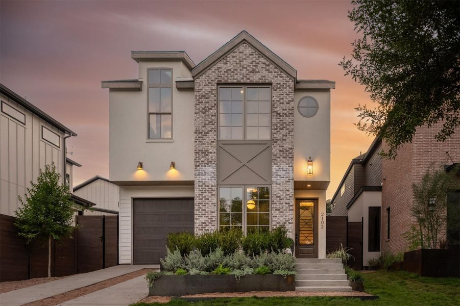 Sleek architectural design details this modern exterior featuring a prominent brick facade and integrated garage. Sleek architectural design details this modern exterior featuring a prominent brick facade and integrated garage.