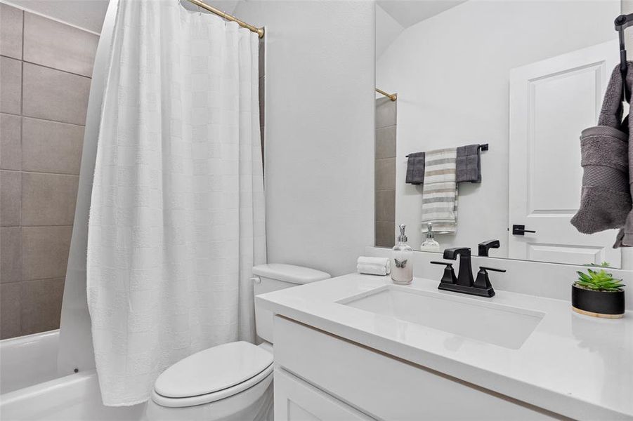 Full bathroom featuring shower / bath combination with curtain and vanity