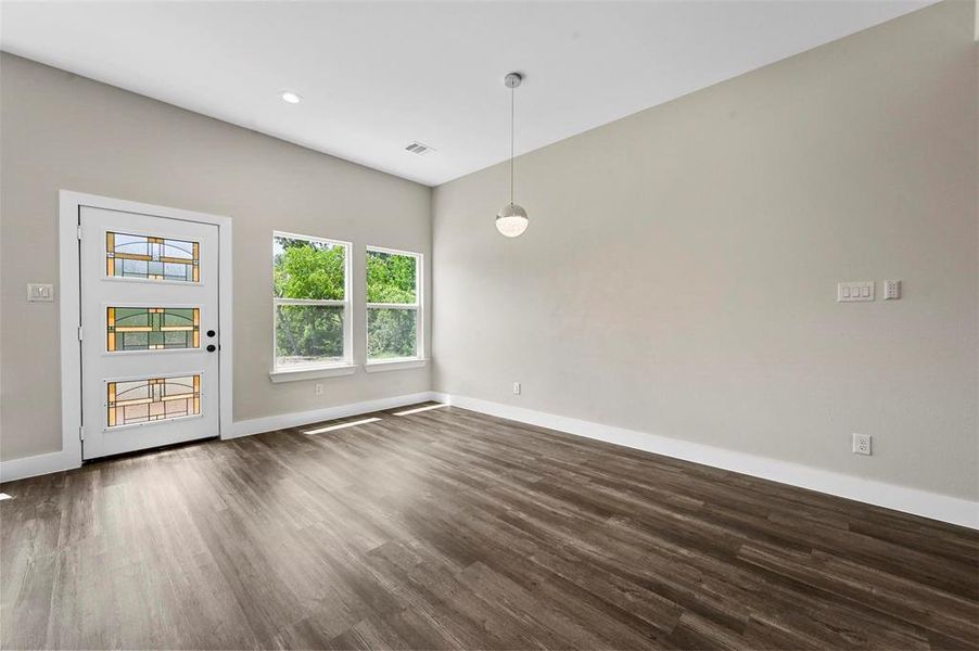 Empty room with dark wood-type flooring