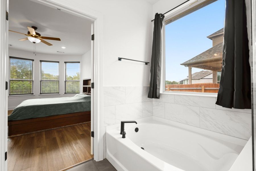 Full bathroom featuring ensuite bath, a bath, ceiling fan, dark tile patterned flooring, and recessed lighting Full bathroom featuring ensuite bath, a bath, ceiling fan, dark tile patterned flooring, and recessed lighting