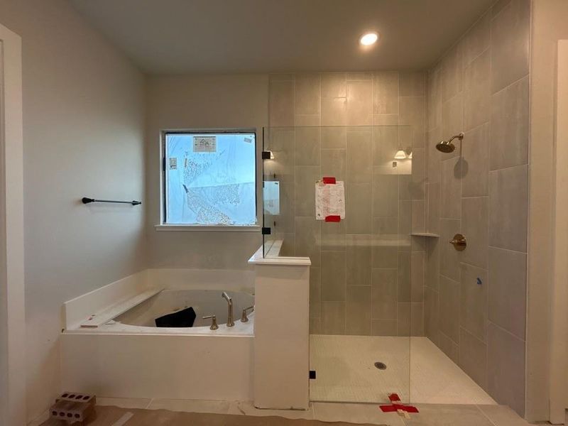 Bathroom with a bath, a walk in shower, and recessed lighting