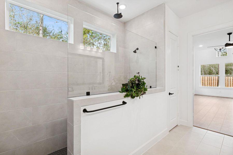 Large walk-in shower with rain shower head is a great place to unwind at the end of a llong day!
