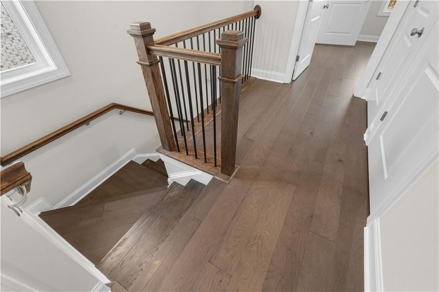 Stairs with wood-type flooring and baseboards