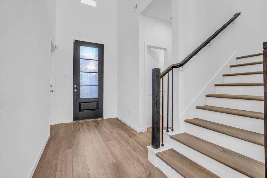 Main Entry & Interior Next Gen Access: A dramatic, light-filled foyer with soaring ceilings, modern railing, and immediate interior access to the Next Gen suite, allowing connection without stepping outside. Main Entry & Interior Next Gen Access: A dramatic, light-filled foyer with soaring ceilings, modern railing, and immediate interior access to the Next Gen suite, allowing connection without stepping outside.