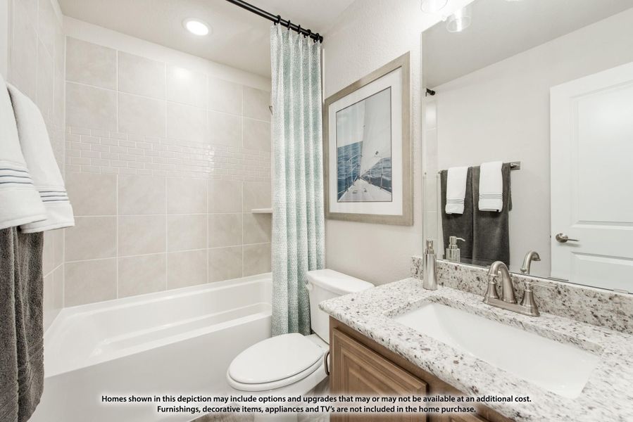 Bathroom with tiled tub and shower, granite vanity countertop, and wood cabinets Bathroom with tiled tub and shower, granite vanity countertop, and wood cabinets