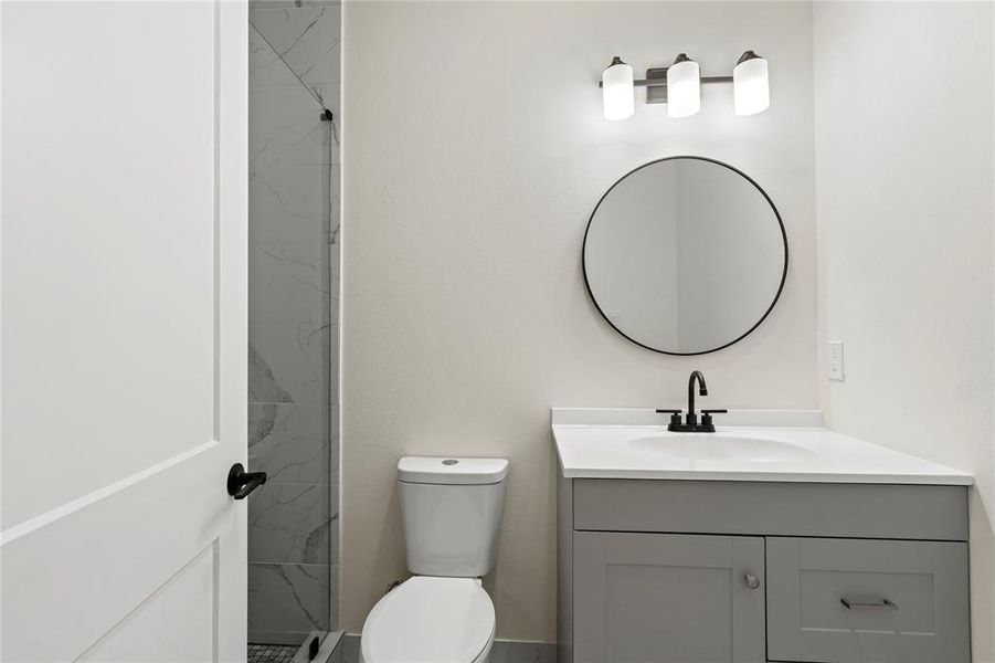 Full bathroom featuring vanity and a marble finish shower Full bathroom featuring vanity and a marble finish shower
