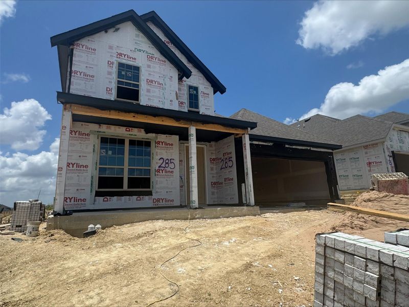 Property under construction featuring a garage and a shingled roof