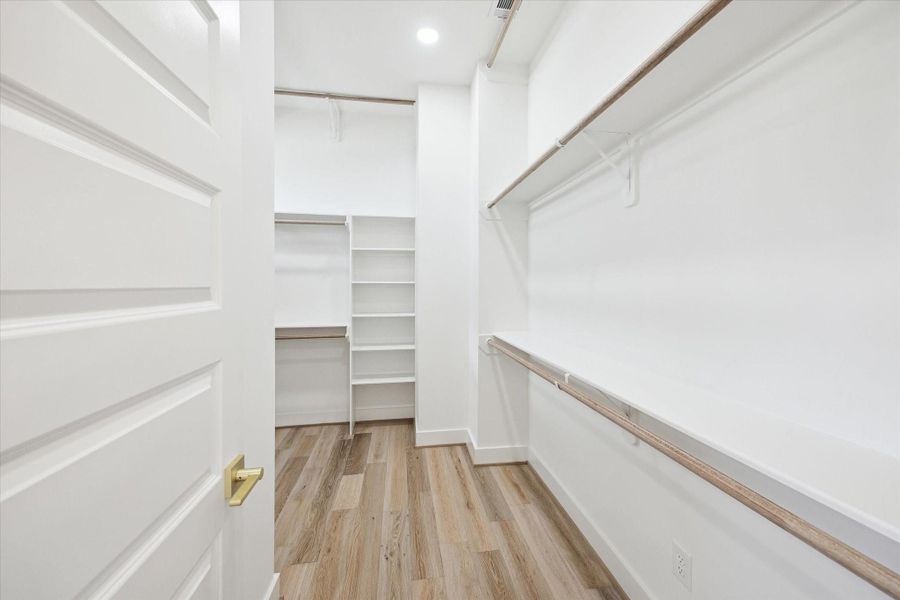 HUGE walk in closet with 3 rows of clothing storage, off primary bath. This is the closet of your dreams!