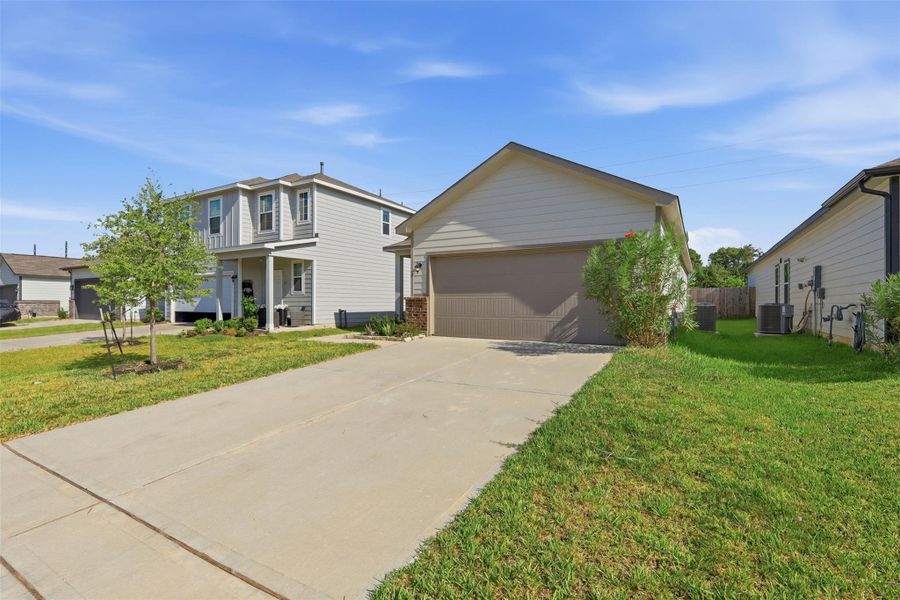 Front exterior of a new home in Barrett Crossing, Crosby, TX, highlighting curb appeal (Image 14).