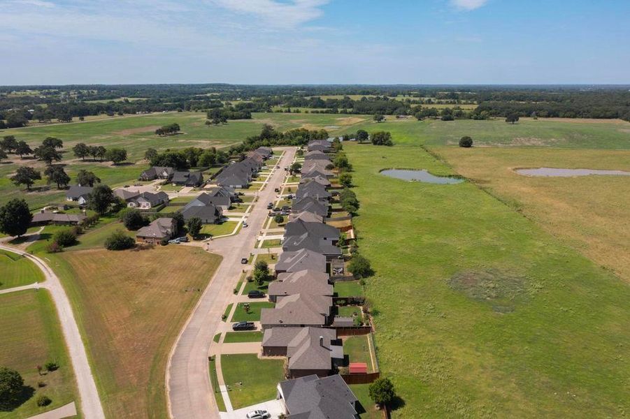 View of property location with a large body of water and nearby suburban area