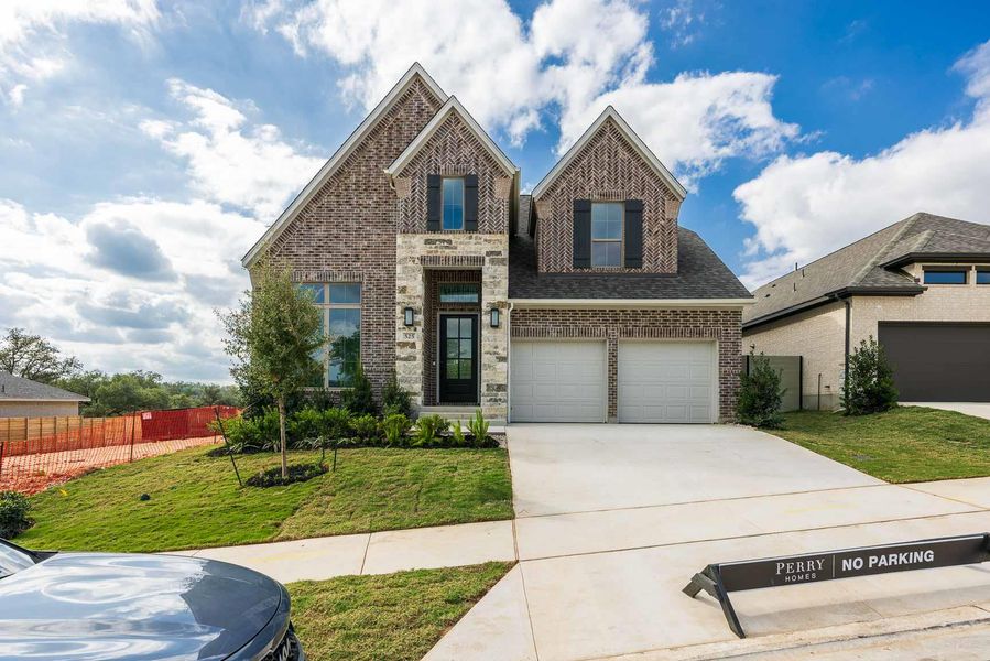 Front exterior of a new home in Wolf Ranch 51', Georgetown, TX, highlighting curb appeal (Image 2).