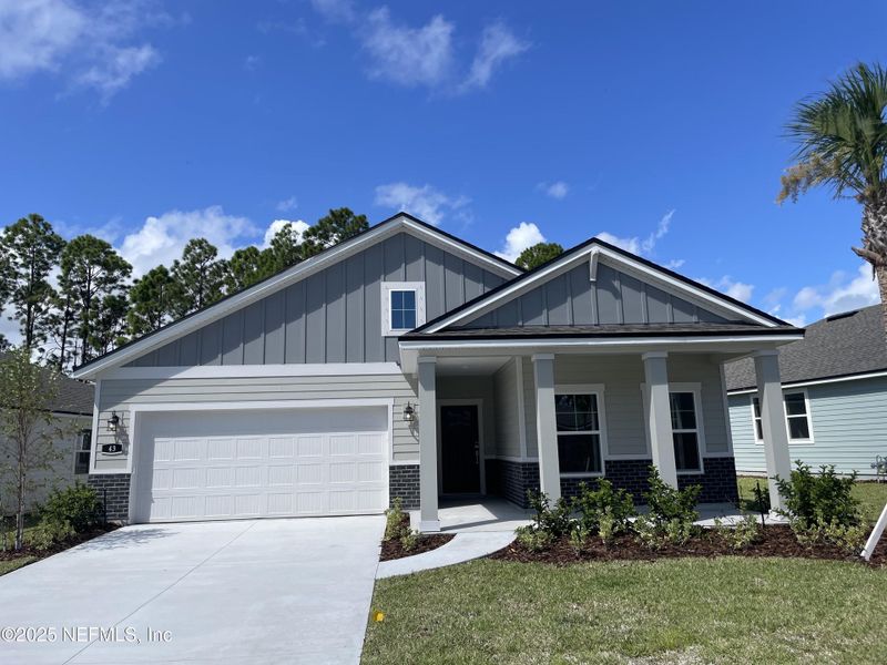 Front exterior of a new home in The Magnolia Series at Reserve East, Flagler Beach, FL, highlighting curb appeal (Image 21).