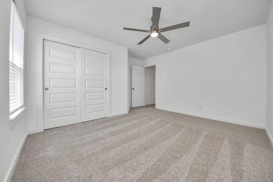 Generously sized secondary bedrooms featuring spacious closets, soft and inviting carpeting underfoot, large windows allowing plenty of natural light, and the added touch of privacy blinds for your personal retreat. Sample photo of completed home with similar floor plan. Actual colors and selections may vary.