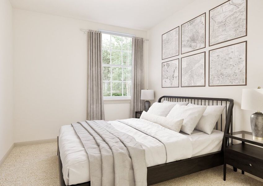 Cozy bedroom featuring a black bed frame, light gray blankets, framed maps on the wall, and a bedside lamp by a large window. Cozy bedroom featuring a black bed frame, light gray blankets, framed maps on the wall, and a bedside lamp by a large window.