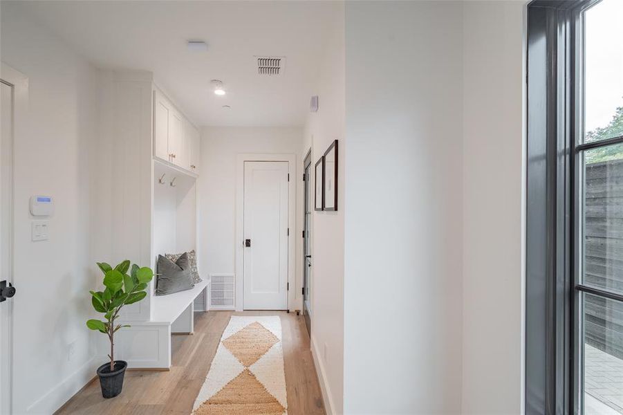 Mudroom with light hardwood / wood-style floors