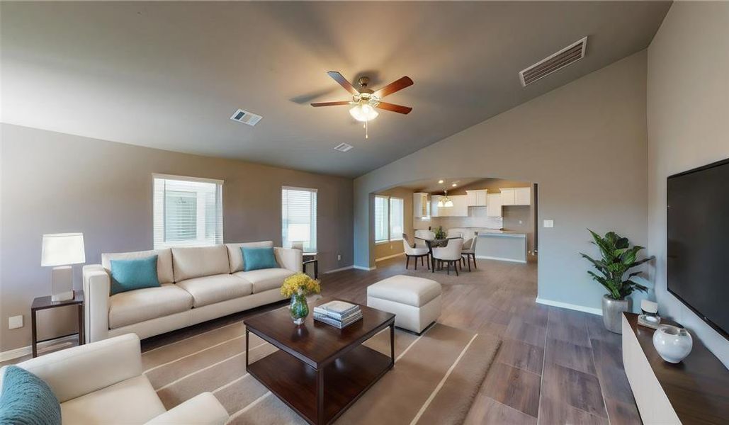 Enjoy a seamless blend of styleand functionality in this expansiveliving area, highlighted by its sleektile floors, modern ceiling fan, andlarge windows that flood the spacewith natural light. The open floorplan facilitates effortlessmovement between the livingroom and the kitchen, perfect forboth everyday living andentertaining guests. This is apicture of an Elise Floor Plan withanother Saratoga Homes.