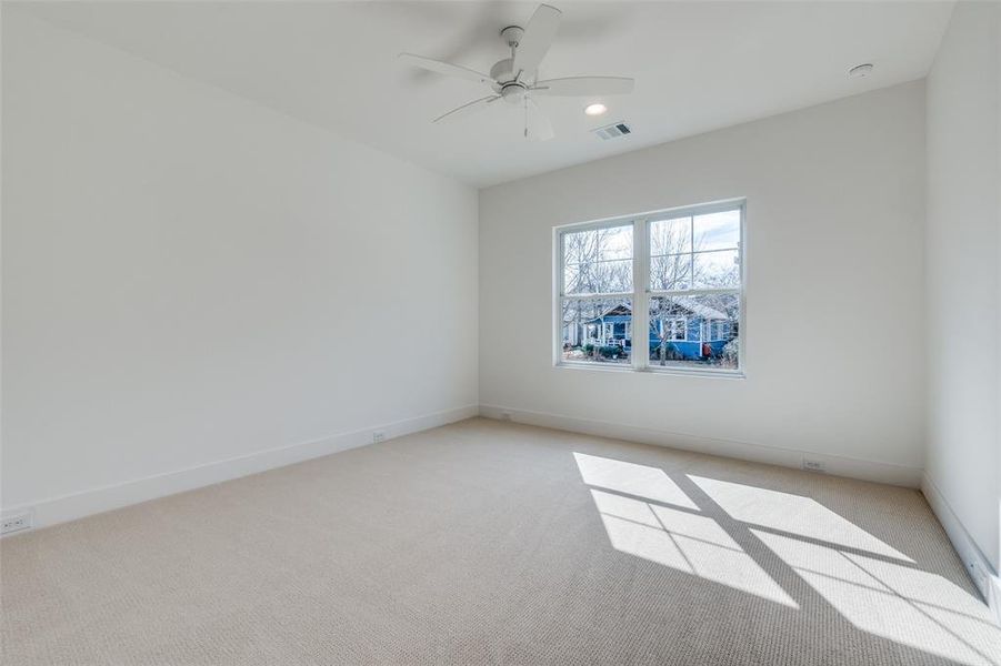 Carpeted empty room with ceiling fan