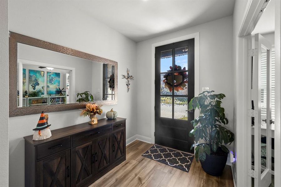 Entrance foyer featuring light wood finished floors and baseboards Entrance foyer featuring light wood finished floors and baseboards