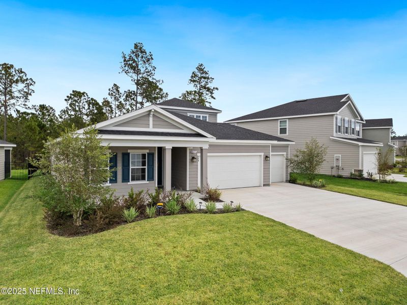 Front exterior of a new home in Seminole Palms Single-Family Homes, Palm Coast, FL, highlighting curb appeal (Image 21).