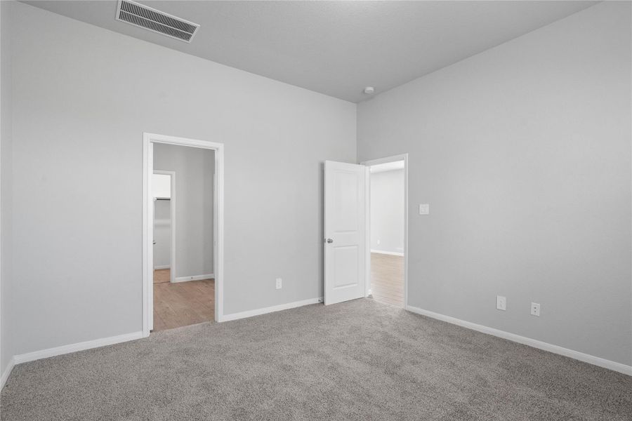 The private primary suite efficiently connects the sleeping area with the dedicated bathroom and generous closet.