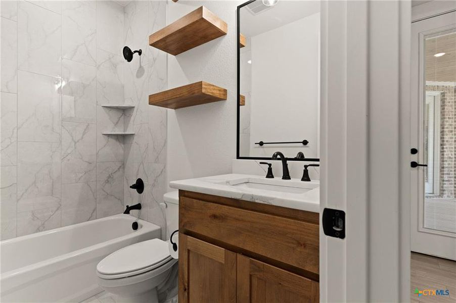 Bathroom with vanity and bathing tub / shower combination