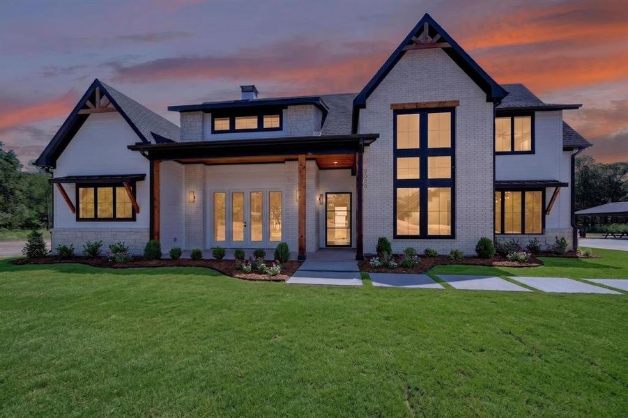 An twilight view showcasing the striking
contemporary facade defined by vast expanses of glass and soaring windows. An twilight view showcasing the striking
contemporary facade defined by vast expanses of glass and soaring windows.