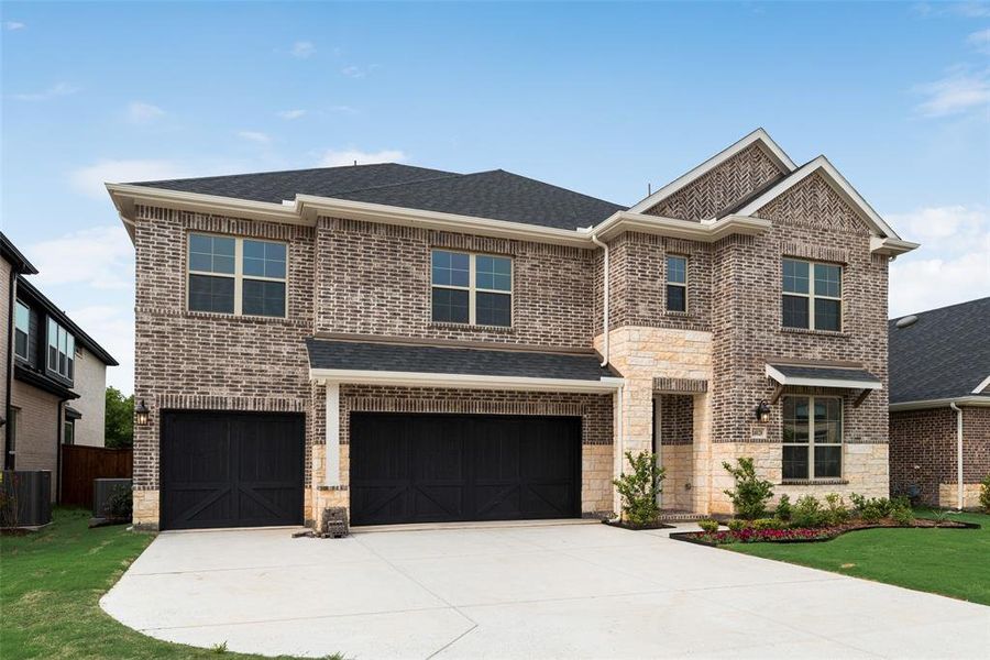 Front exterior of a new home in Valencia On The Lake, Little Elm, TX, highlighting curb appeal (Image 24). Front exterior of a new home in Valencia On The Lake, Little Elm, TX, highlighting curb appeal (Image 24).