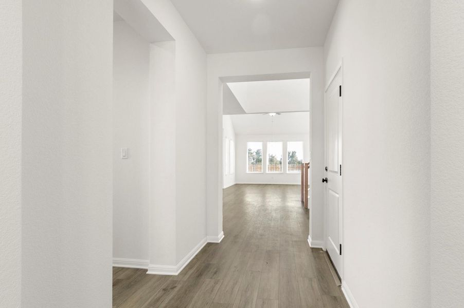 Corridor with dark wood finished floors and baseboards
