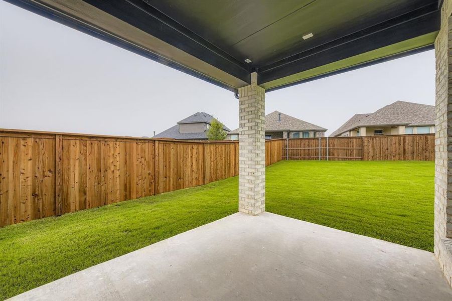 Fenced backyard featuring a patio area