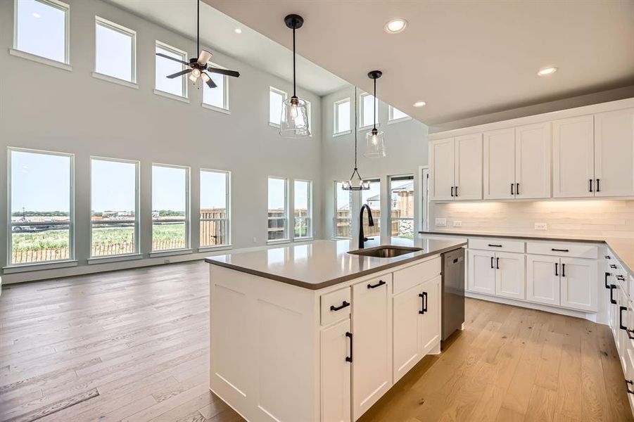 Kitchen with a sink, dishwasher, a ceiling fan, light wood-style floors, and recessed lighting Kitchen with a sink, dishwasher, a ceiling fan, light wood-style floors, and recessed lighting