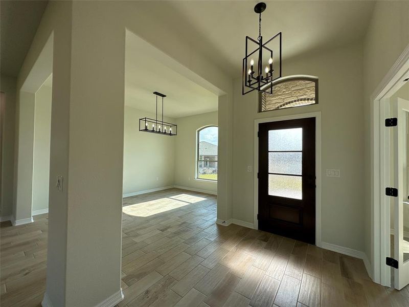 Foyer featuring a chandelier and wood tiled floors
